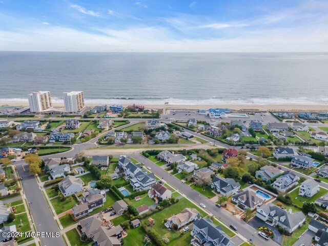 birds eye view of property with a view of the beach and a water view