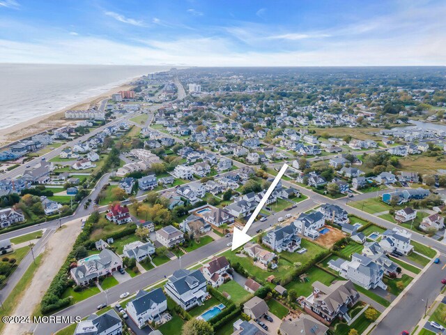 bird's eye view with a view of the beach and a water view