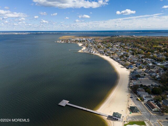 aerial view featuring a water view and a view of the beach