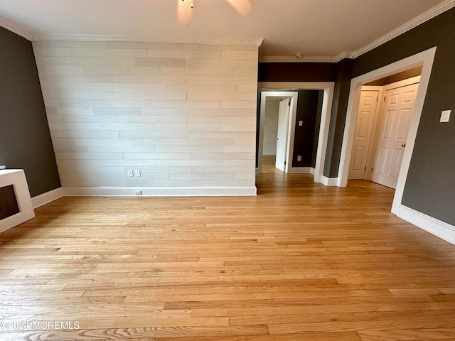 spare room with crown molding and light hardwood / wood-style floors