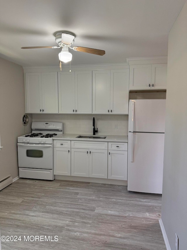 kitchen with decorative backsplash, white appliances, sink, and white cabinets