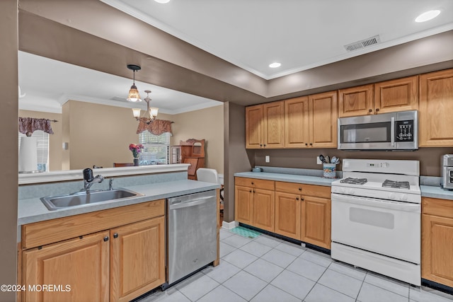 kitchen featuring pendant lighting, stainless steel appliances, sink, and a healthy amount of sunlight