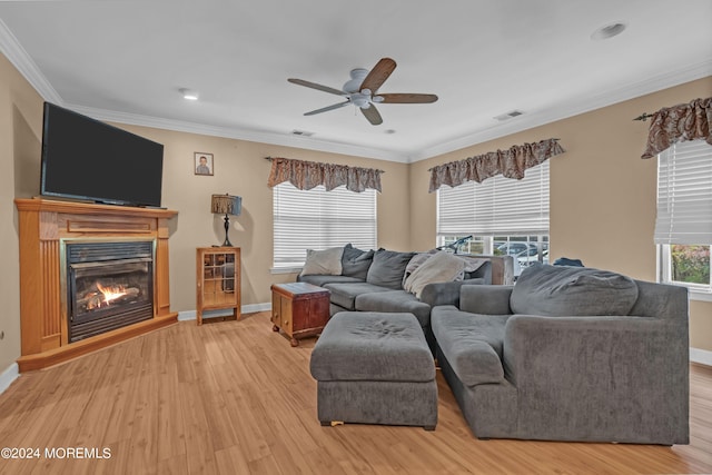 living room featuring ornamental molding, ceiling fan, and light hardwood / wood-style flooring