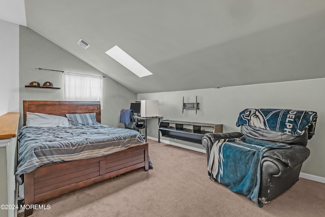 carpeted bedroom with vaulted ceiling with skylight