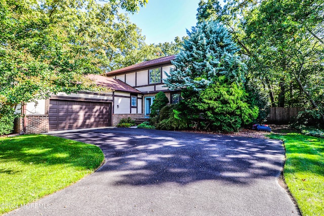 view of front of home featuring a front yard and a garage