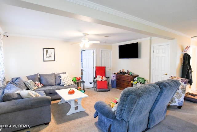 living room with ceiling fan, ornamental molding, and light carpet