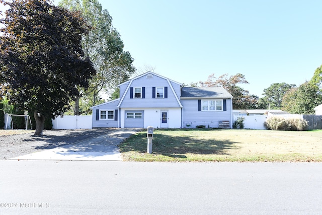 view of front of property featuring a garage and a front lawn