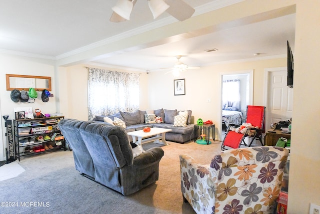 carpeted living room with ornamental molding and ceiling fan