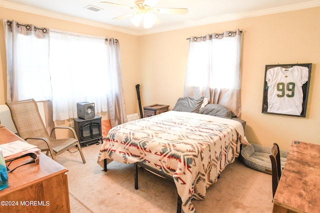 carpeted bedroom featuring ceiling fan and ornamental molding