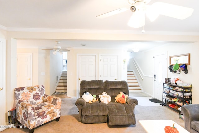 living room featuring light carpet, ornamental molding, and ceiling fan