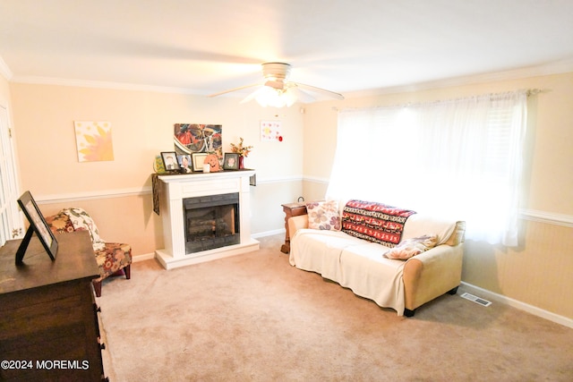 living room with ornamental molding, carpet flooring, and ceiling fan