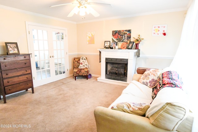 carpeted living room with ornamental molding and ceiling fan