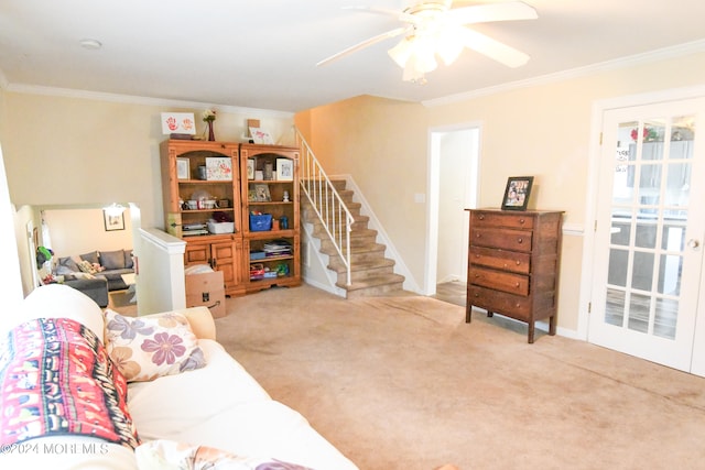 living room with ceiling fan, light colored carpet, and ornamental molding