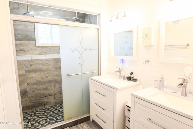 bathroom with walk in shower, wood-type flooring, and vanity