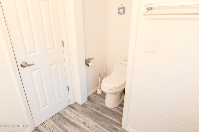 bathroom featuring toilet and wood-type flooring