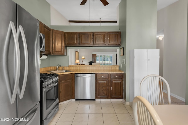 kitchen featuring ceiling fan, sink, light tile patterned flooring, and appliances with stainless steel finishes