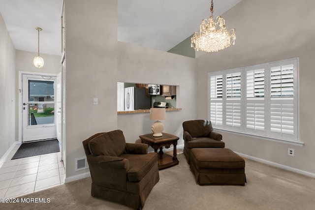 sitting room featuring carpet floors, high vaulted ceiling, and a notable chandelier