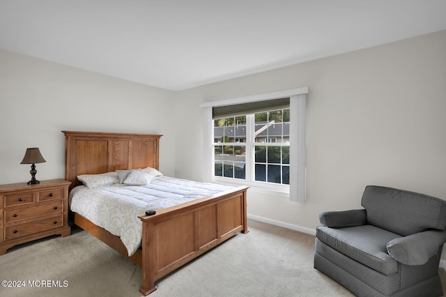 bedroom featuring light carpet