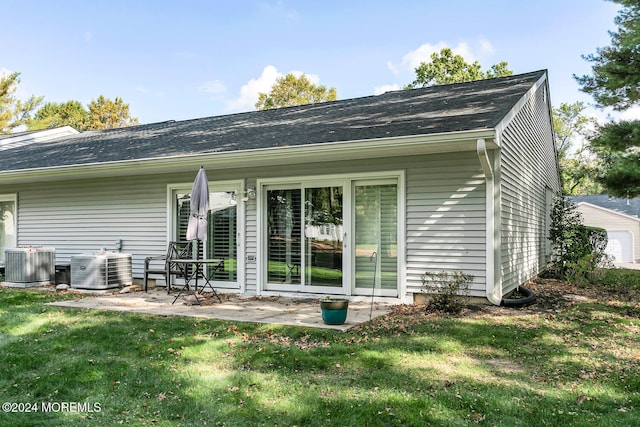 back of property with cooling unit and a yard