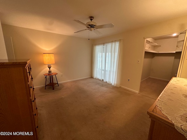 interior space featuring carpet flooring and ceiling fan