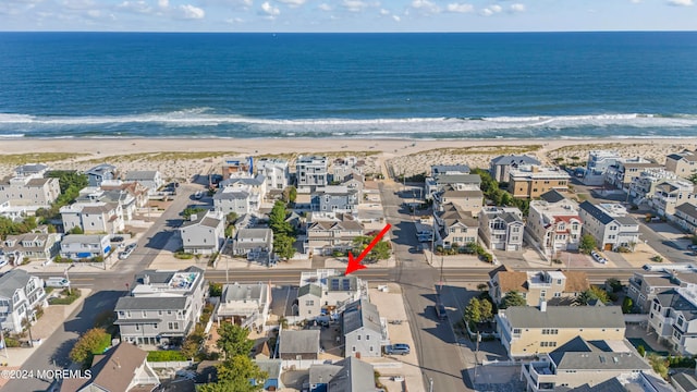 drone / aerial view featuring a view of the beach and a water view