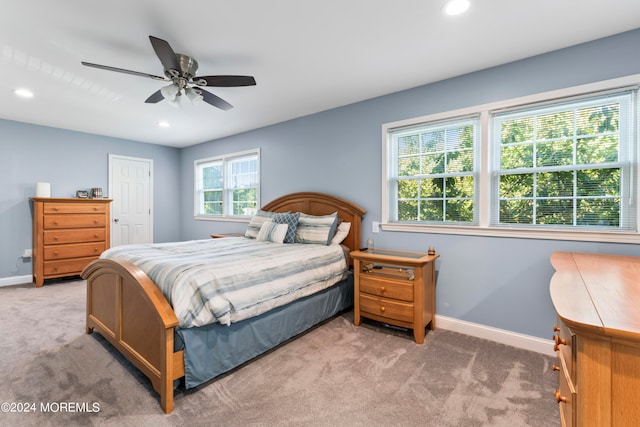 bedroom featuring light carpet and ceiling fan