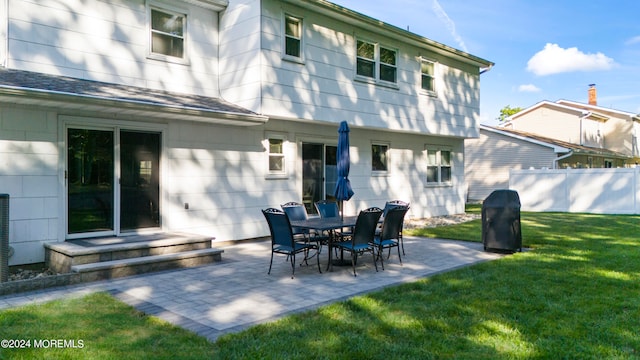 rear view of property with a patio area and a yard