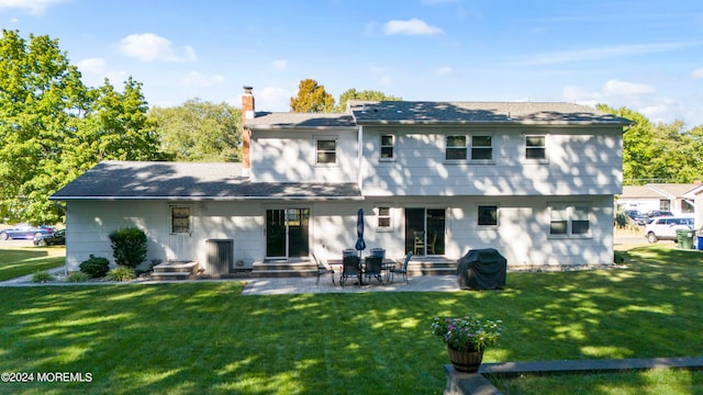 back of property featuring a lawn and a patio area