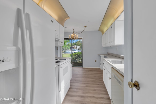 kitchen featuring light wood-type flooring, white cabinets, an inviting chandelier, white appliances, and decorative light fixtures