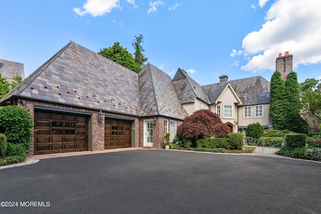 tudor-style house with a garage