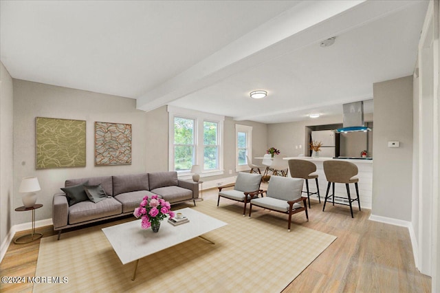 living room with beam ceiling and light hardwood / wood-style flooring