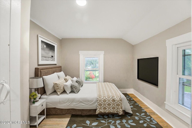 bedroom featuring vaulted ceiling and hardwood / wood-style floors