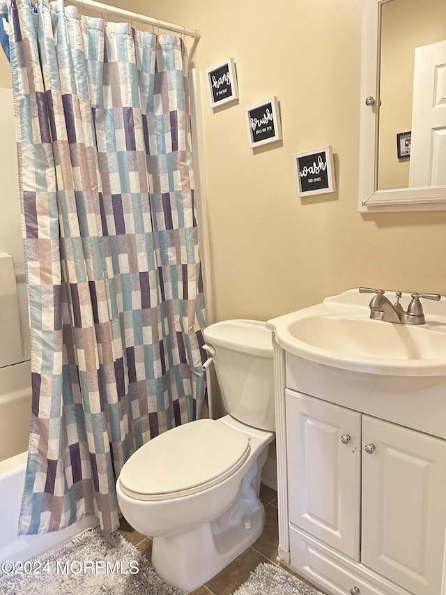 full bathroom with shower / bath combo with shower curtain, tile patterned flooring, vanity, and toilet