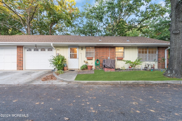 ranch-style home with a front yard and a garage