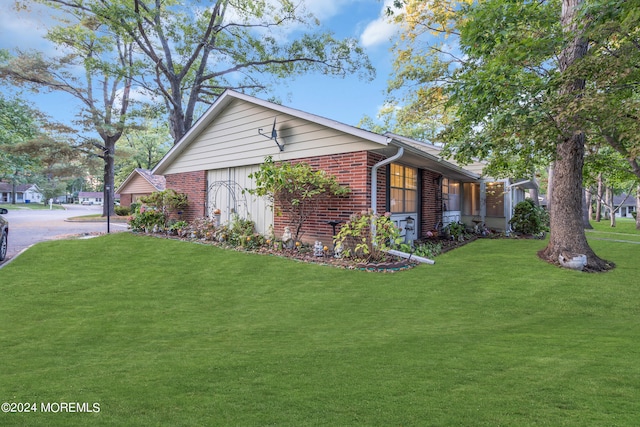 view of side of property with a yard