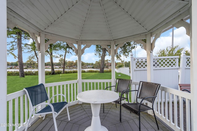 deck featuring a gazebo and a lawn