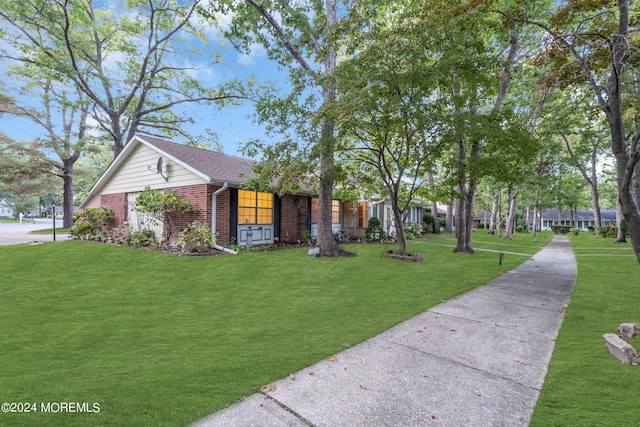 ranch-style home featuring a front yard