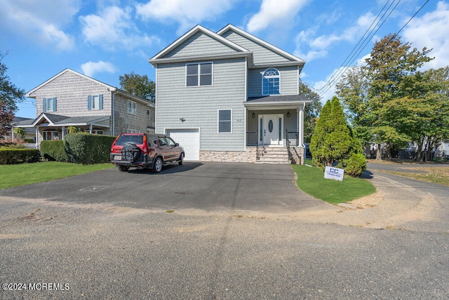 view of front of property featuring a porch and a garage