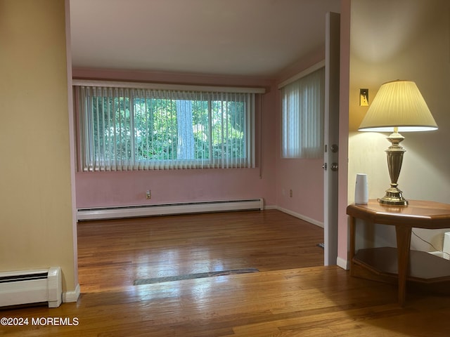 spare room with light hardwood / wood-style flooring and baseboard heating