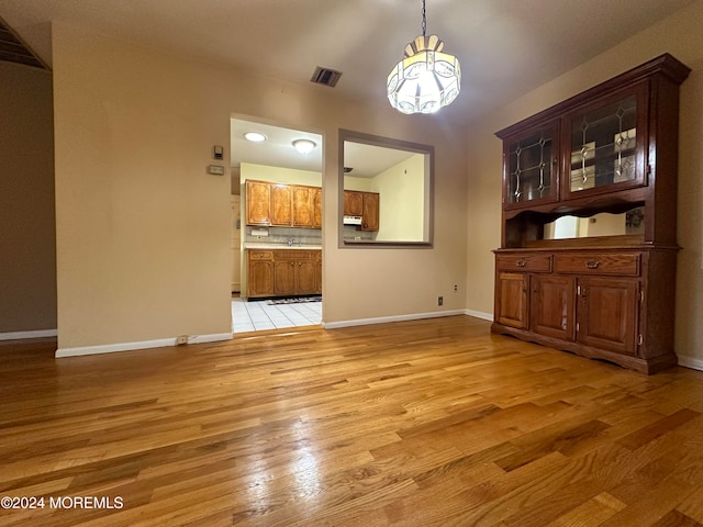 unfurnished dining area with light hardwood / wood-style floors