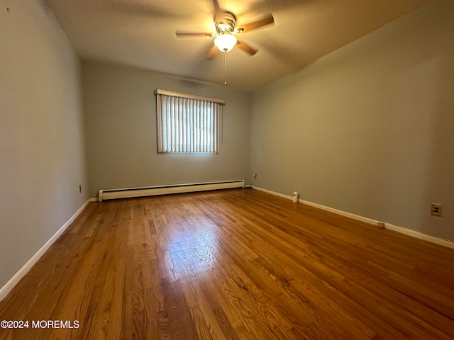 unfurnished room featuring a baseboard heating unit, hardwood / wood-style flooring, and ceiling fan