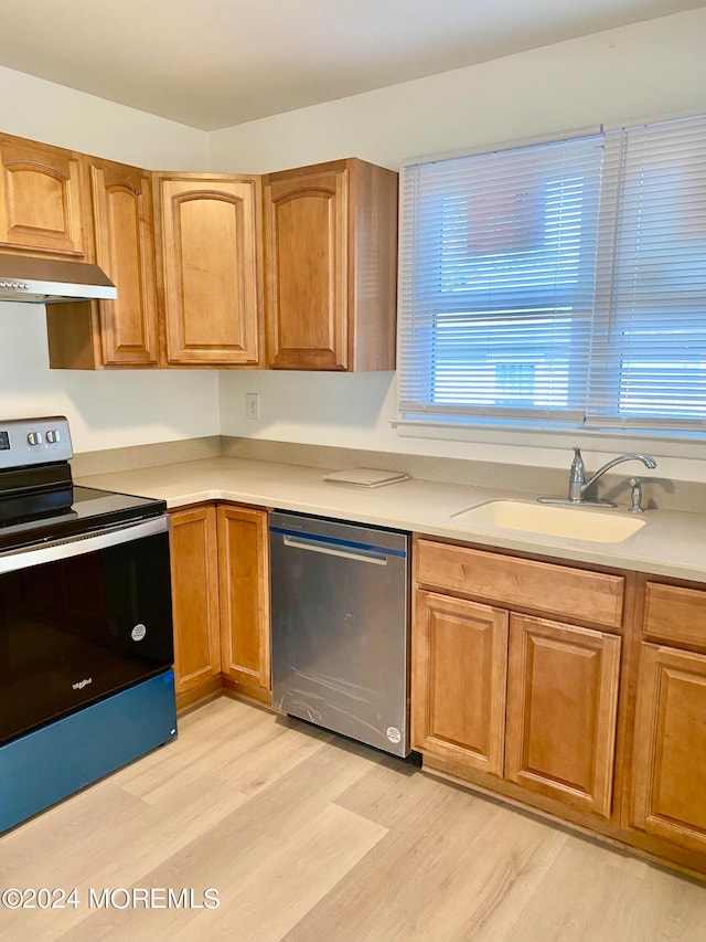 kitchen with electric stove, dishwasher, light wood-type flooring, and sink