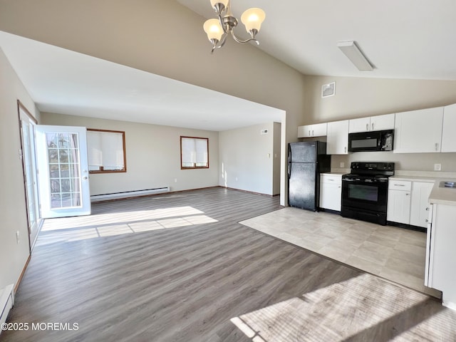 kitchen featuring white cabinets, open floor plan, baseboard heating, light countertops, and black appliances