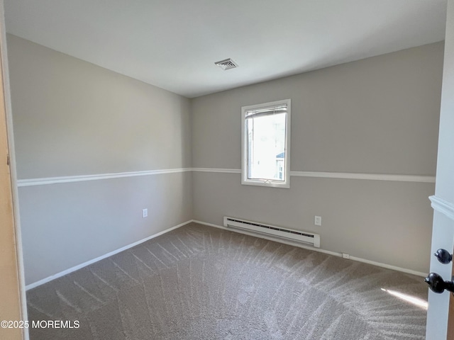 empty room with carpet floors, a baseboard radiator, visible vents, and baseboards