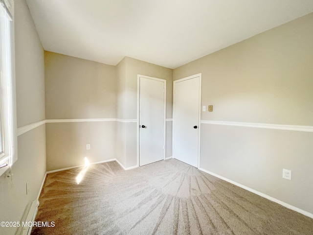 carpeted spare room with baseboards