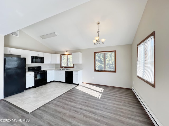 kitchen featuring light countertops, hanging light fixtures, baseboard heating, white cabinetry, and black appliances