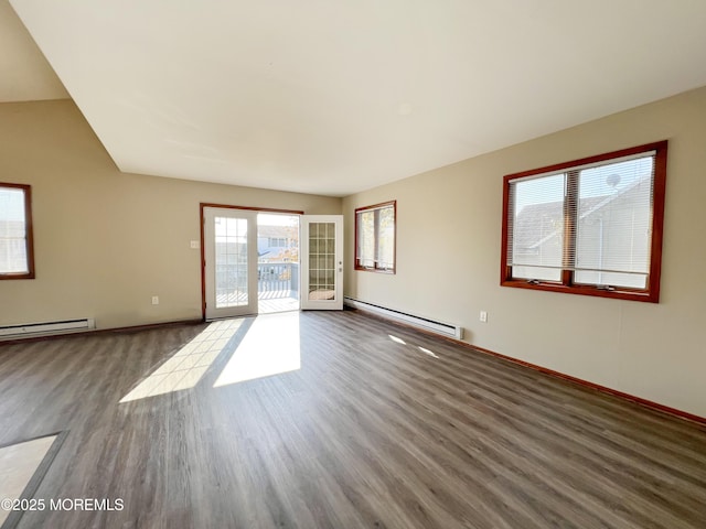 empty room featuring baseboards, a baseboard heating unit, dark wood finished floors, and french doors