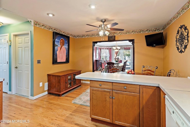 kitchen with dishwasher, kitchen peninsula, ceiling fan with notable chandelier, and light hardwood / wood-style floors