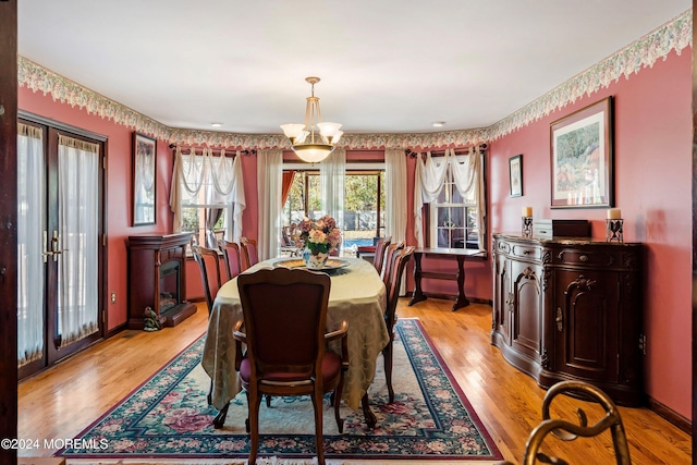 dining room featuring an inviting chandelier and light hardwood / wood-style floors