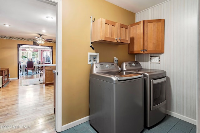 laundry room with cabinets, light hardwood / wood-style floors, washer and clothes dryer, and ceiling fan